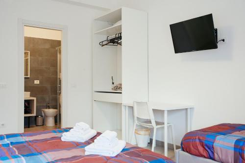 a room with a bed and a desk and a tv at CIVICO 15 BED BREAKFAST in Mercato San Severino
