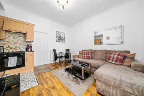 a living room with a couch and a kitchen at Charming 1-Bedroom Home in Alexandria in Alexandria