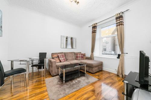 a living room with a couch and a table at Charming 1-Bedroom Home in Alexandria in Alexandria