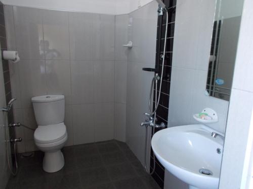 a bathroom with a toilet and a sink at Leisure Home Mirissa in Mirissa