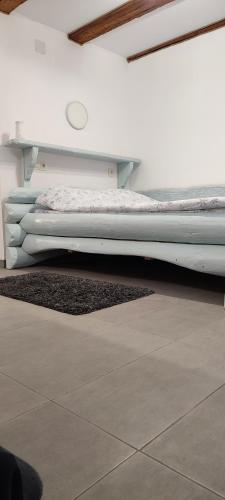 a bed sitting in the corner of a room at Camera de familie in Vatra Dornei