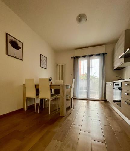 a kitchen and dining room with a table and chairs at Home Cavour - Casalecchio - in Casalecchio di Reno