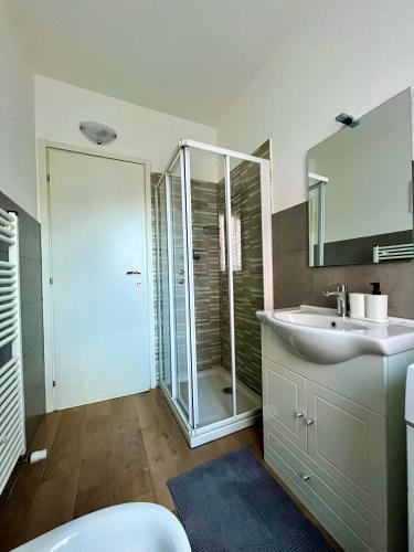 a bathroom with a glass shower and a sink at Home Cavour - Casalecchio - in Casalecchio di Reno