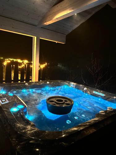 a hot tub with a tire in it at night at Tenna 48 in Stryn