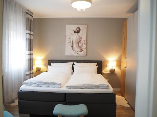 a bedroom with a bed and a blue chair at Apartment Schlossblick - Top location in Idar-Oberstein
