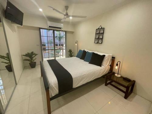 a bedroom with a large bed and a television at CBD Esplanade Location - Quiet & Comfortable in Darwin