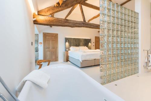 a bedroom with a white bed and a large mirror at Carden Laithe By Birch Stays in Skipton
