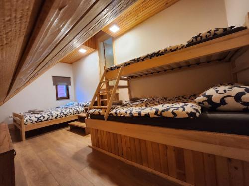 two bunk beds in a room with wooden floors at Holiday home Maša - Kupres in Kupres