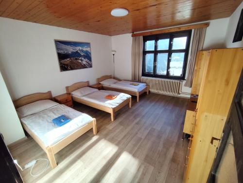 a room with two beds and a window at Pension 21 in Prague