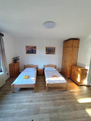 a room with two beds and wooden cabinets at Pension 21 in Prague