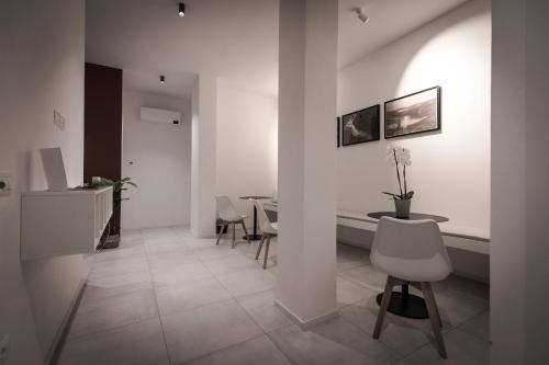 a hallway with a table and chairs in a room at Dantis Rooms in Ravenna