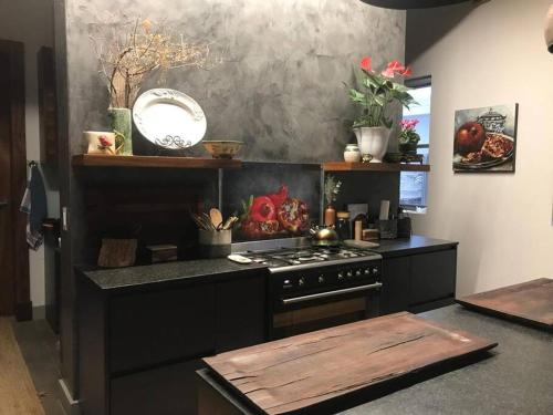a kitchen with a stove and a counter top at Jubilee in Buffelsbaai