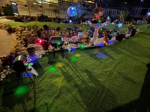 a garden with lights on the grass at night at סוויטות עין השמש eye sun in Arad