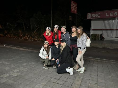 a group of people posing for a picture on the street at The Lava Bali Villa and Hot Spring in Kintamani