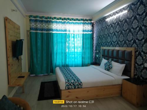 a bedroom with a bed with blue curtains at hill view in Shimla