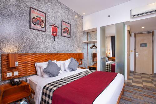 a hotel room with a bed in a room at THE 1O1 Bandung Dago in Bandung