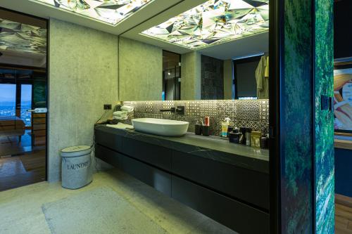 a bathroom with a sink and a large mirror at Villa Bella in Sarajevo