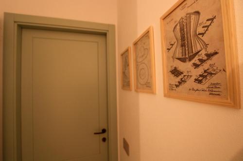 a room with two pictures on the wall and a door at Casa Sartoria - Guest House in Pergola