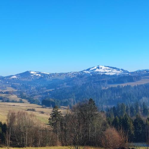 a view of a mountain range with snow at Kopanicówki in Jaworzynka