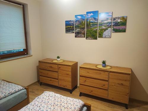 a room with two twin beds and two dressers at Kopanicówki in Jaworzynka