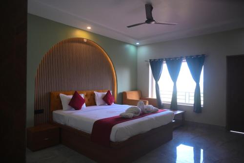 a bedroom with a large bed and a window at Shivanta Resort and Hotel in Deoghar
