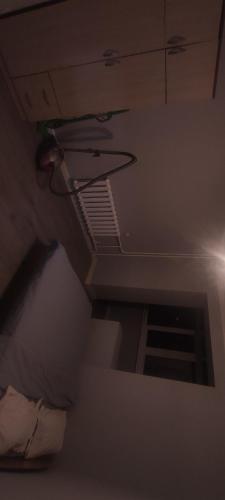 a room with a ceiling with a window and a bed at Совмин in Bishkek