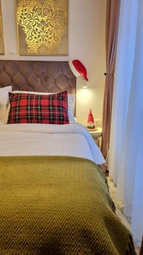 a bedroom with a bed with a red pillow on it at Charming studio apt in city center in Zadar