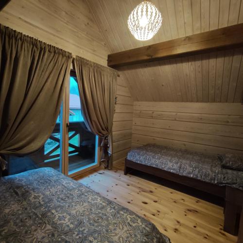 a bedroom with a bed and a window in a room at Užmiesčio trobelė in Mackėnai