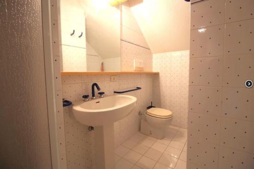 a bathroom with a sink and a toilet at Appartamento Sestriere in Sauze di Cesana