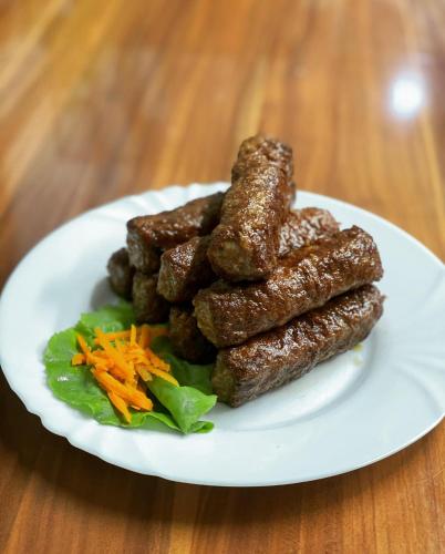 a plate of food with meatballs and carrots on a table at Hanul Lui Bogdan Economy INN in Făget