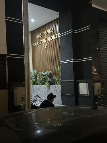 a man sitting in front of a building at Magnificent Cozy New Luxury Condo in Prime Casablanca Location in Les Camps