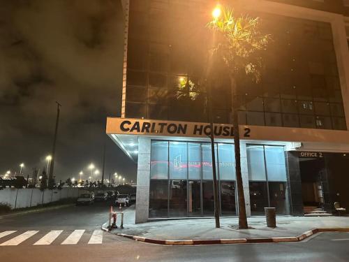a building with a sign for a carillon hospital at Magnificent Cozy New Luxury Condo in Prime Casablanca Location in Les Camps