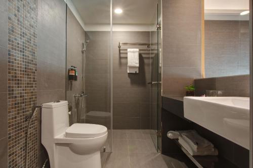 a bathroom with a toilet and a sink and a shower at EG Hostel in Nantou City