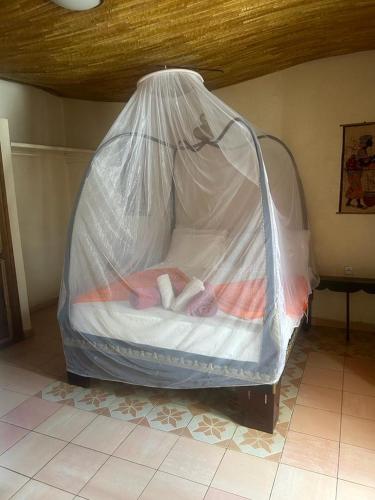 a bed with a plastic sheet on it in a room at Riad côté jardin in Saly Portudal