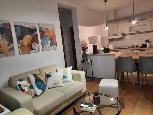 a living room with a couch and a kitchen at NJANJA apartmani Zlatibor in Zlatibor