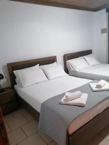 two beds sitting next to each other in a bedroom at Matenia’s house in Mángana