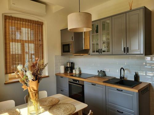 a kitchen with a table with a vase of flowers at Velflík - ubytování v srdci Krušných hor in Abertamy