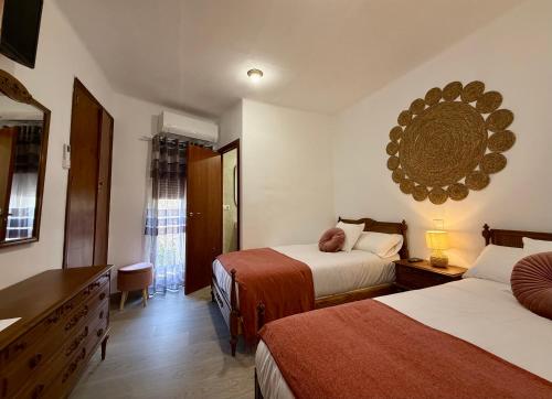 a hotel room with two beds and a mirror at A R Benjamín in Artana