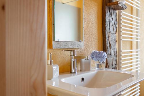 a bathroom with a white sink and a mirror at Casa Anna in Trichiana