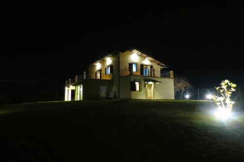 a house at night with its lights on at Characteristic restored farmhouse with 360 degree views in Montefino