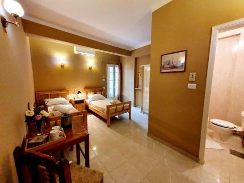 a bedroom with a bed and a desk and a room at Cream Hostel in Luxor
