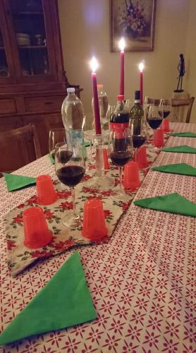 a table with wine glasses and candles on it at Casa Vacanze Piazza Apartment 2 in SantʼAndrea di Conza