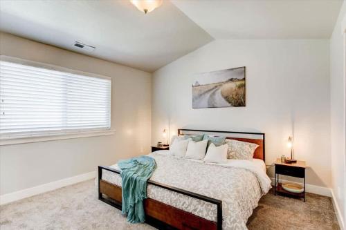a bedroom with a large bed and a window at Golf Course Close By Minutes from UVU BYU in Orem