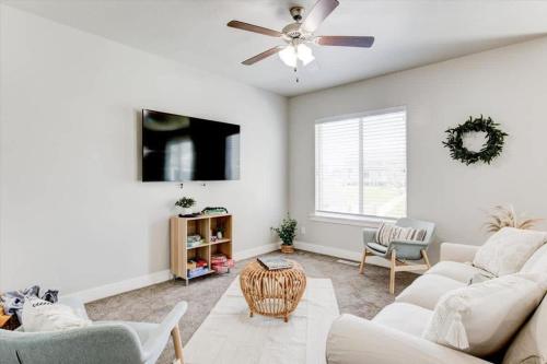 a living room with a couch and a ceiling fan at Golf Course Close By Minutes from UVU BYU in Orem