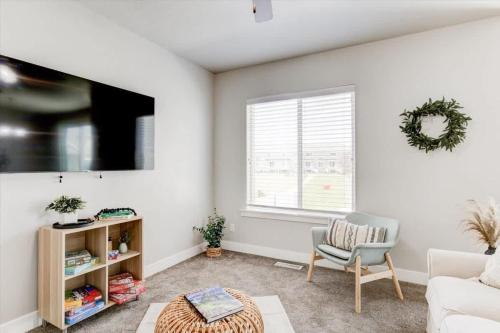 a living room with a couch and a chair at Golf Course Close By Minutes from UVU BYU in Orem
