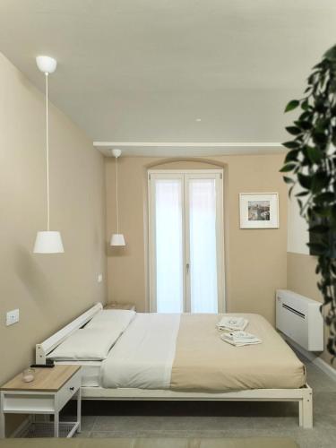 a bedroom with a large bed and a window at Appartamento Dalì in Brescia