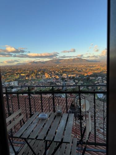 a picnic table on a balcony with a view of a city at Il Vicoletto in Artena