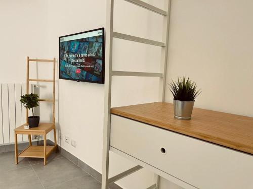 a living room with a tv on a wall at Palermo Inn Boutique Hotel in Palermo