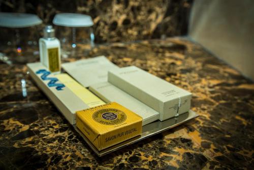 a table with two boxes of cigarettes and a glass at Grand Millennium Sulaimani in As Sulaymānīyah