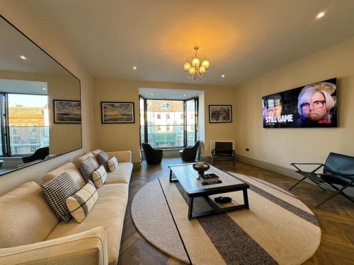 a living room with a couch and a table at Priory Castle Apartment, Tynemouth in Tynemouth